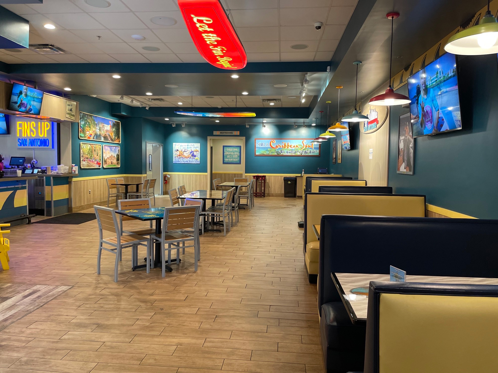 Main dining area with booths to the right, tables in the middle and the counter on the left